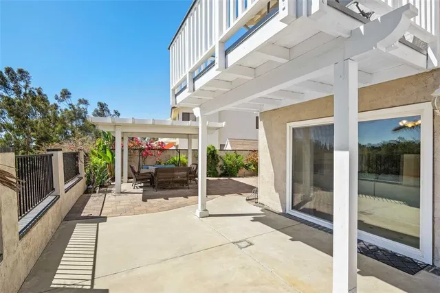 a view of a building with sitting area and glass door