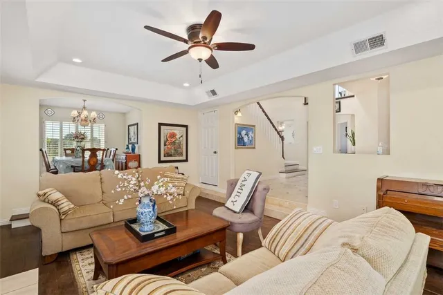 a living room with furniture and a wooden floor