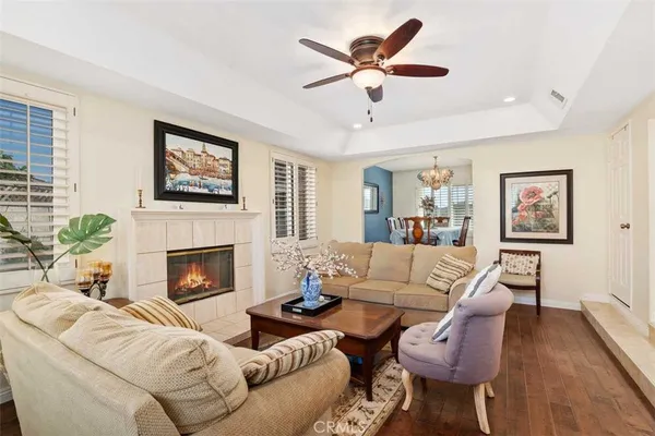 a living room with furniture a fireplace with wooden floor