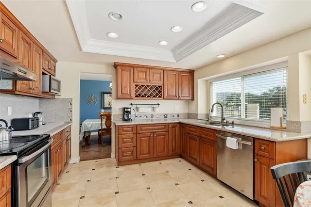 a kitchen with stainless steel appliances granite countertop a sink and cabinets