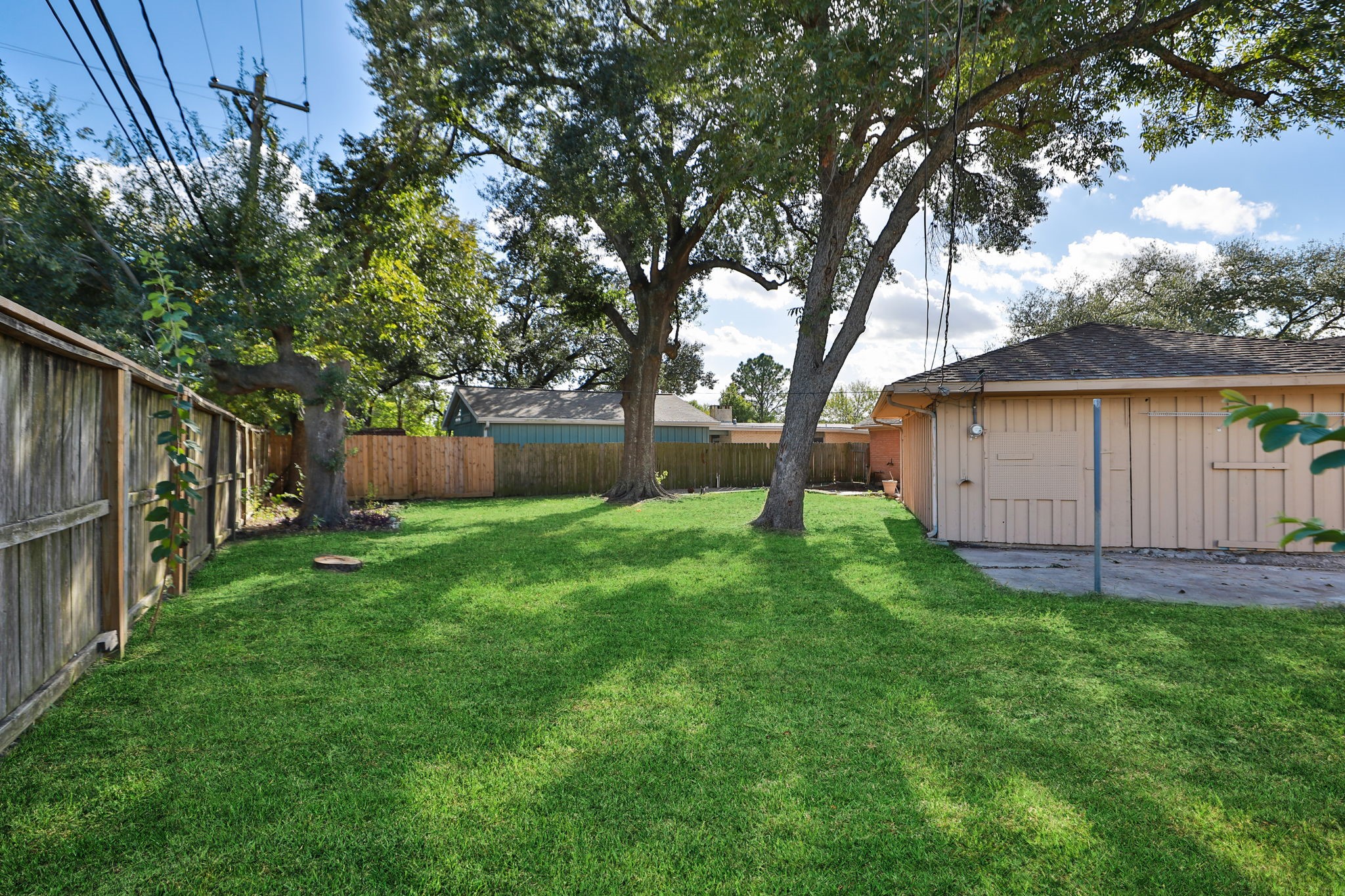 8235 Dover Street Houston, TX 77061 - Photo 31 of 36 a view of a house with backyard and a tree