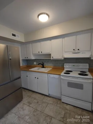 a kitchen with cabinets and appliances