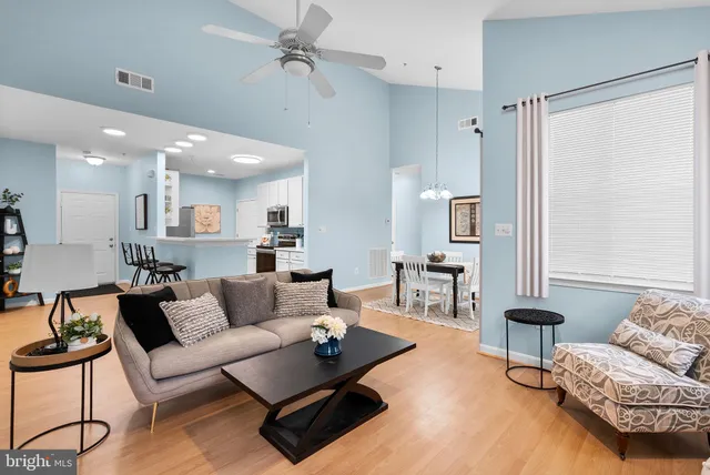 a living room with furniture and a lamp
