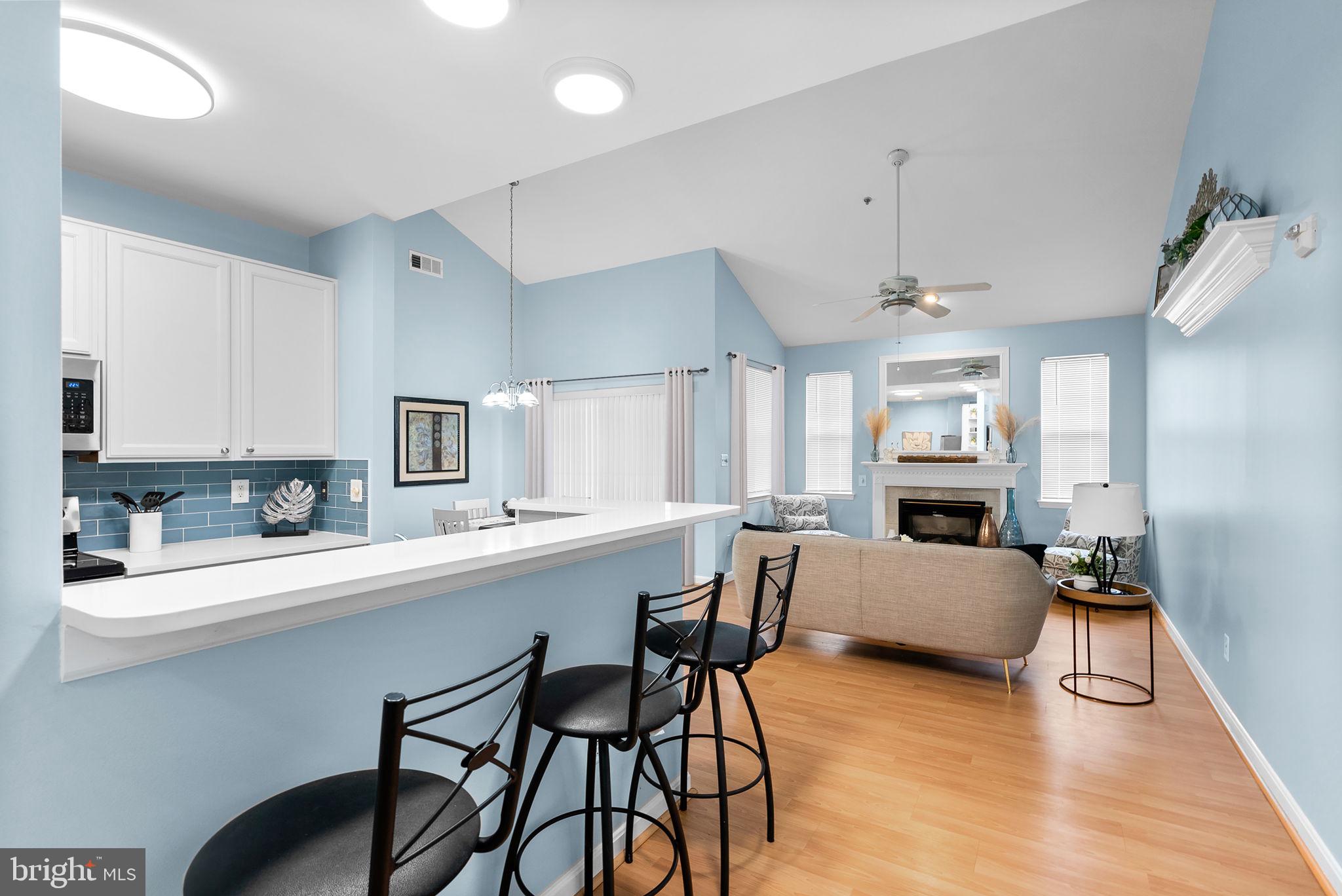 12708 Found Stone Road, Unit 3304 Germantown, MD 20876 - Photo 11 of 40 a kitchen with a dining table chairs refrigerator and sink