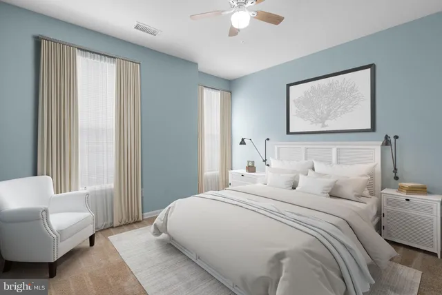 a view of an empty room and chandelier fan