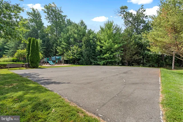 a view of swimming pool in front of residential houses with outdoor space
