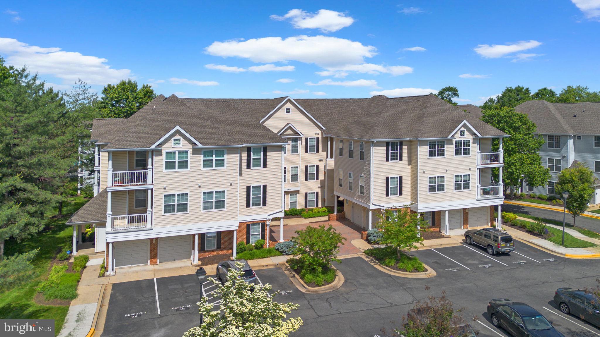 12708 Found Stone Road, Unit 3304 Germantown, MD 20876 - Photo 29 of 40 a view of a white house with a yard and potted plants