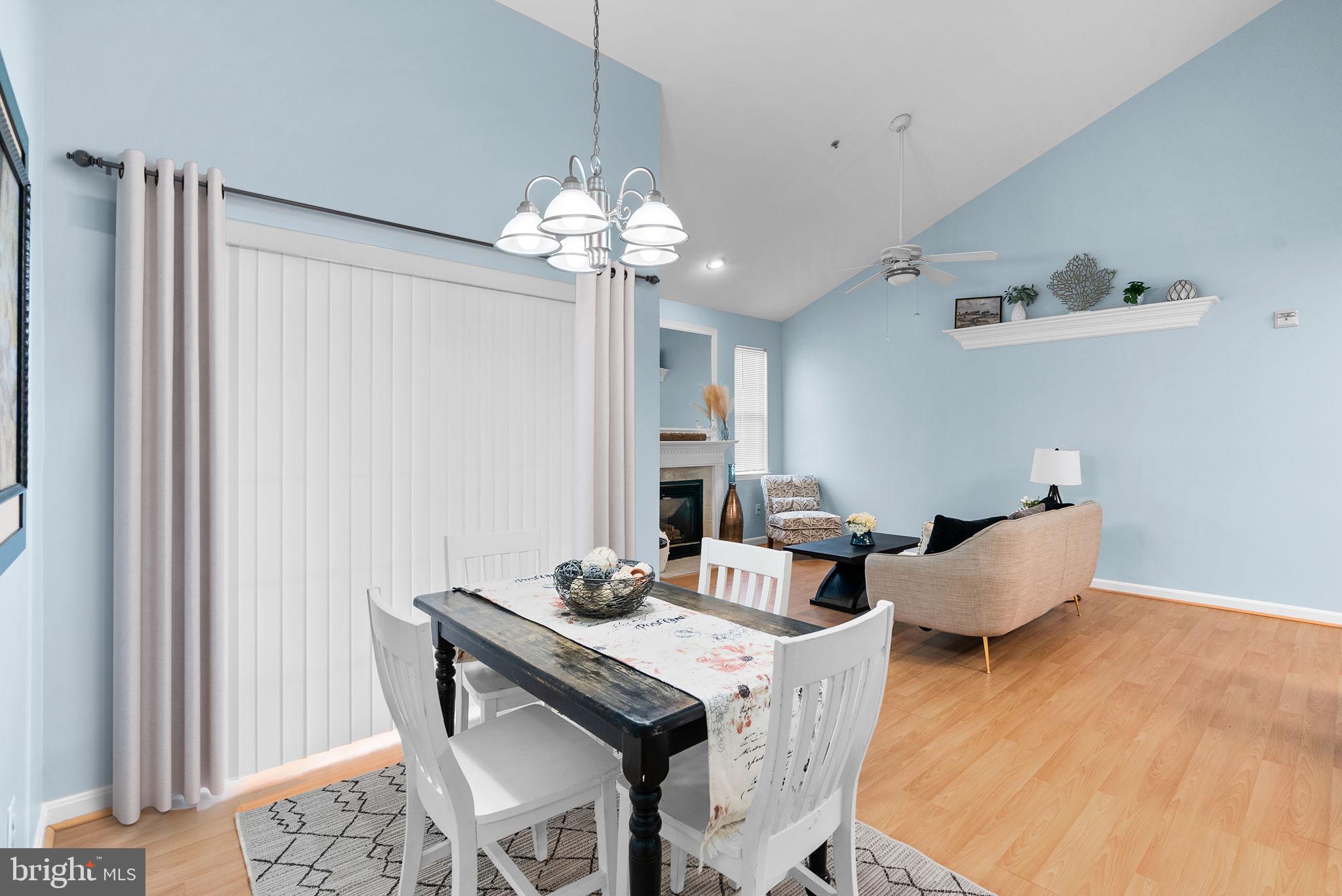 12708 Found Stone Road, Unit 3304 Germantown, MD 20876 - Photo 6 of 40 a view of a dining room with furniture a chandelier and wooden floor