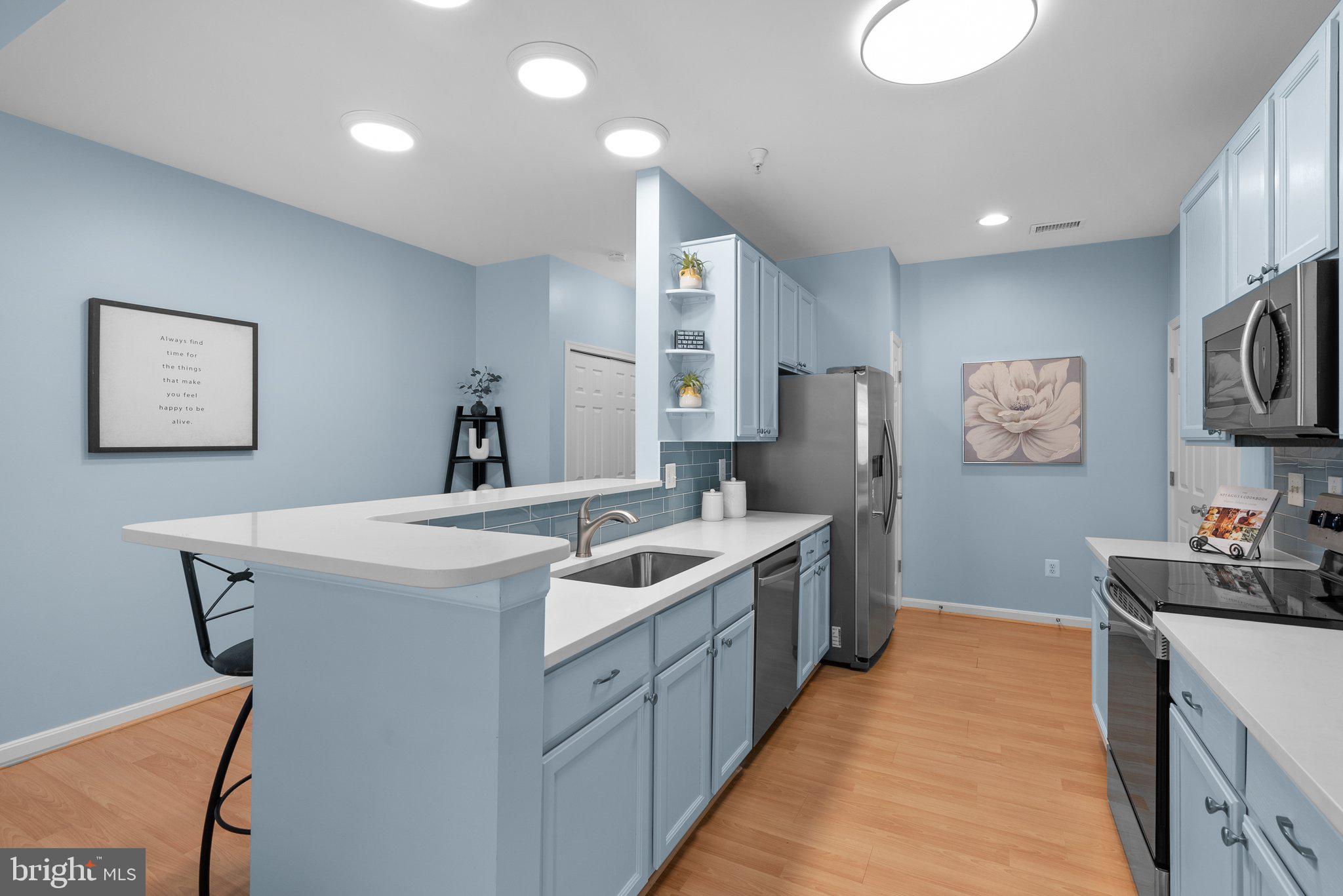 12708 Found Stone Road, Unit 3304 Germantown, MD 20876 - Photo 7 of 40 a kitchen with stainless steel appliances granite countertop a sink stove and refrigerator