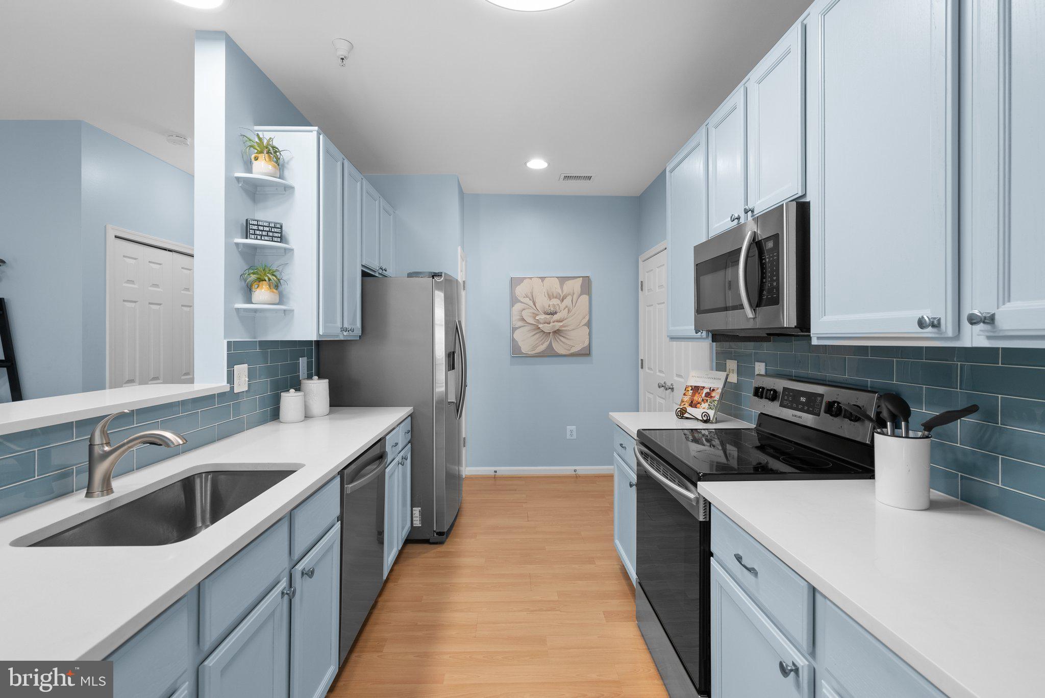 12708 Found Stone Road, Unit 3304 Germantown, MD 20876 - Photo 8 of 40 a kitchen with stainless steel appliances granite countertop a sink stove and refrigerator