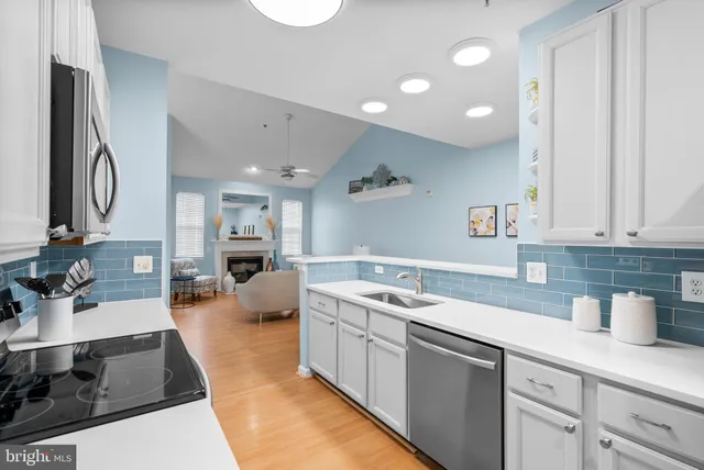 a kitchen with a dining table chairs refrigerator and sink
