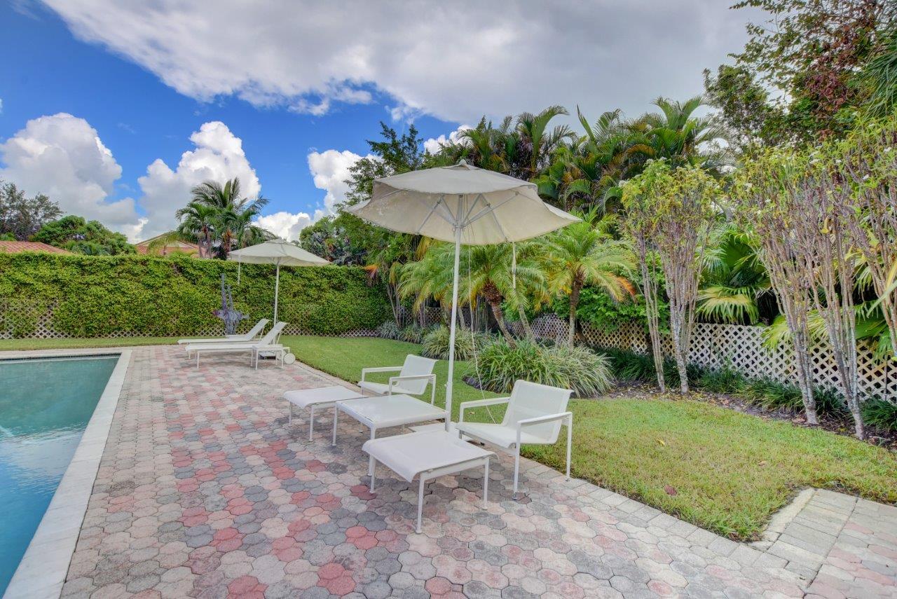 5758 Northwest 24th Terrace Boca Raton, FL 33496 - Photo 34 of 35 a view of a chair and table in backyard of the house