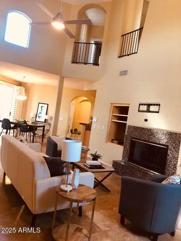a living room with furniture a rug and white walls