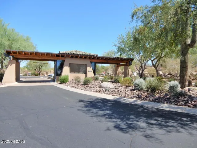 a view of a house with a yard and potted plants