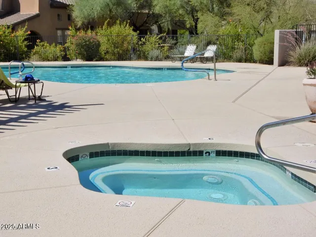 a view of a swimming pool with a yard