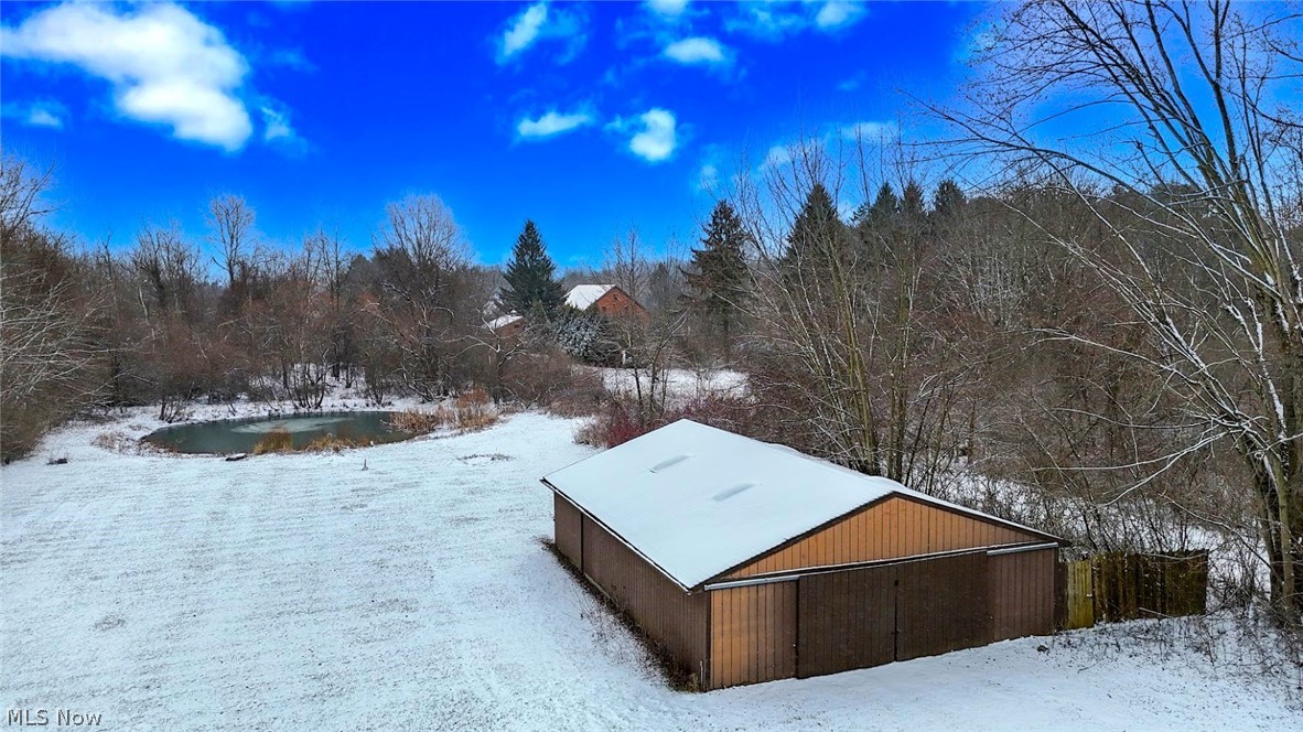 6151 Taylor Road Clinton, OH 44216 - Photo 4 of 49 *BACK YARD HAS FLAT LAND, A POND AND 1200 SQ. FT OUTBUILDING WITH ELECTRIC AND CONCRETE FLOORING ~