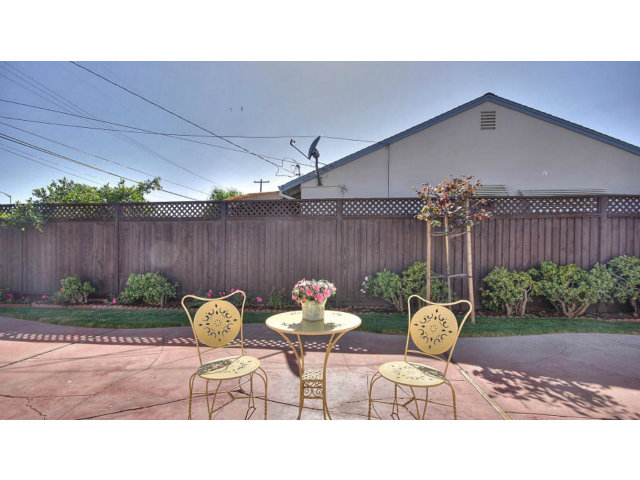 262 Maria Street Santa Clara, CA 95050 - Photo 17 of 22 a backyard with table and chairs potted plants and wooden fence