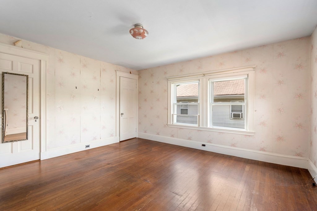 39 Reedsdale Road Milton, MA 02186 - Photo 14 of 25 an empty room with wooden floor and windows