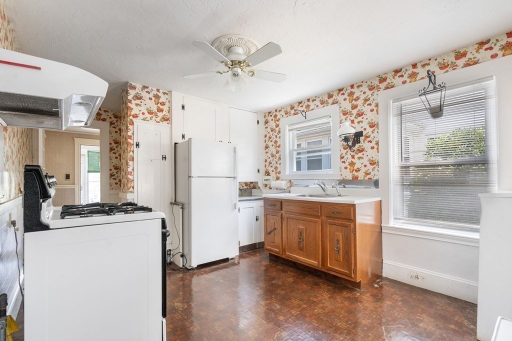 39 Reedsdale Road Milton, MA 02186 - Photo 5 of 25 a kitchen with cabinets wooden floor and stainless steel appliances