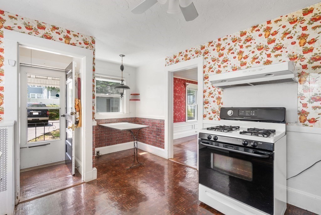 39 Reedsdale Road Milton, MA 02186 - Photo 7 of 25 a kitchen with white cabinets and stainless steel appliances