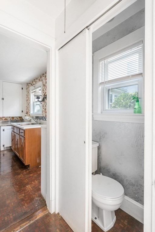 39 Reedsdale Road Milton, MA 02186 - Photo 8 of 25 a bathroom with a toilet a sink and a window