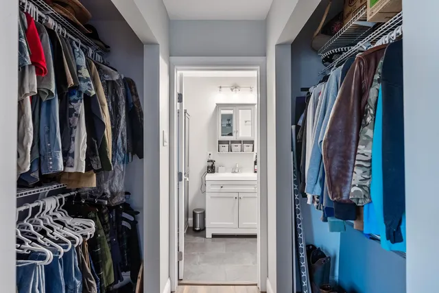 a view of walk in closet with clothes