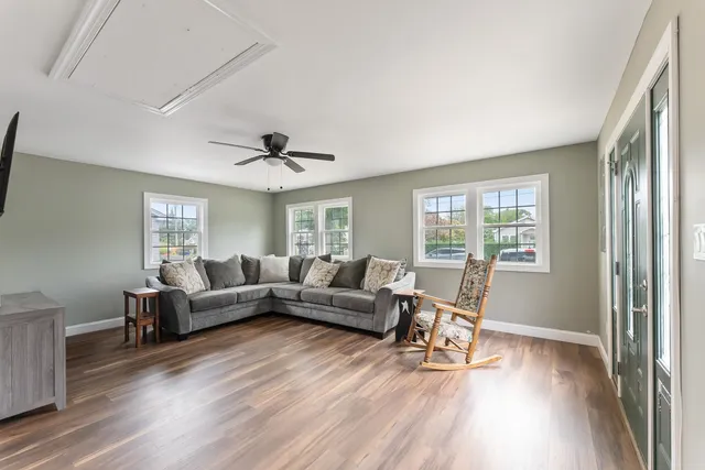 a living room with furniture and a large window