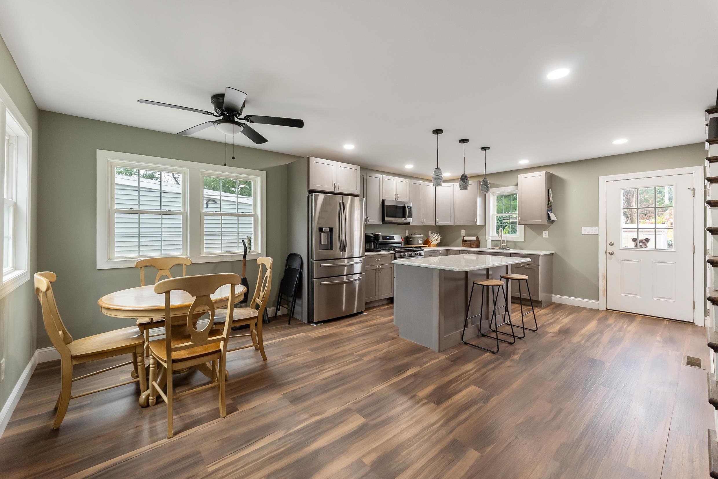 134 Arbor Road Villas, NJ 08251 - Photo 6 of 27 a kitchen with stainless steel appliances kitchen island granite countertop a dining table chairs refrigerator and sink