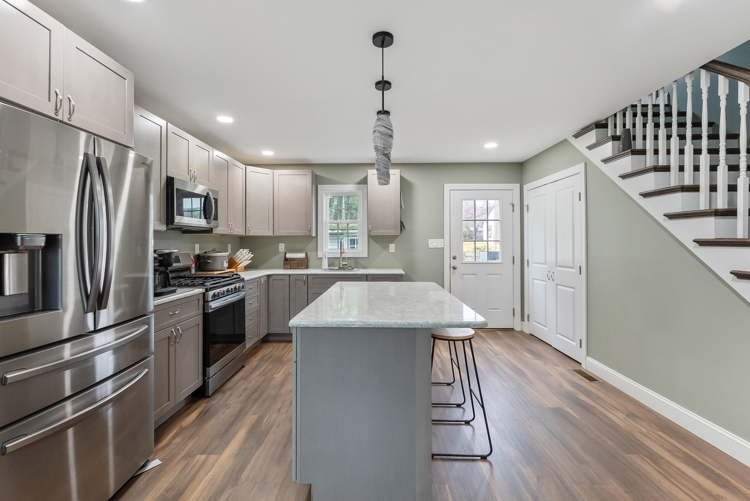 134 Arbor Road Villas, NJ 08251 - Photo 7 of 27 a kitchen with stainless steel appliances kitchen island granite countertop a refrigerator a sink dishwasher a stove and a refrigerator with wooden floor
