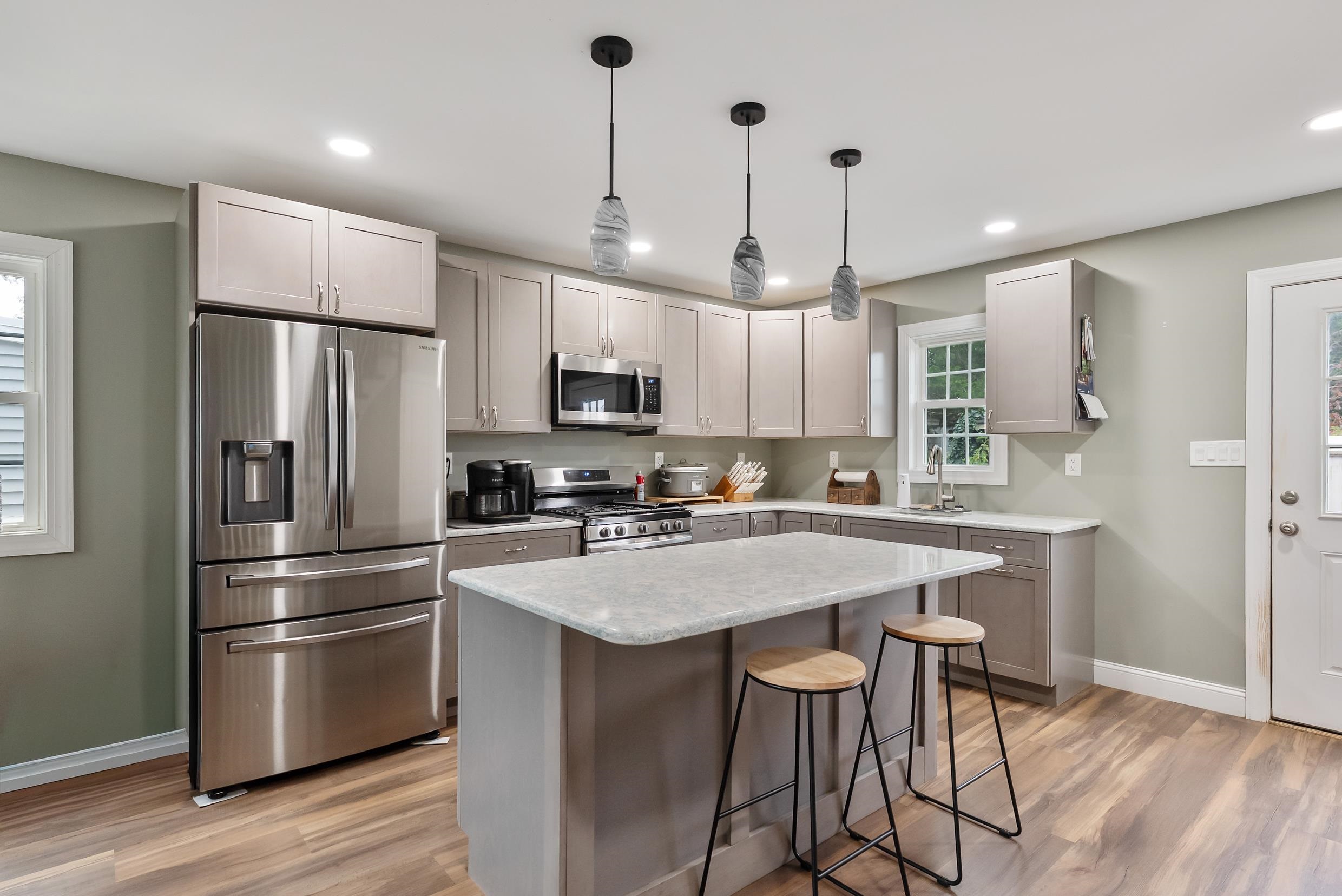 134 Arbor Road Villas, NJ 08251 - Photo 8 of 27 a kitchen with stainless steel appliances granite countertop a refrigerator a sink dishwasher a stove and white cabinets with wooden floor