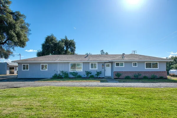 a kitchen with stainless steel appliances white cabinets a sink and a stove
