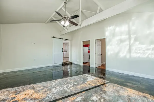 a utility room with closet and windows