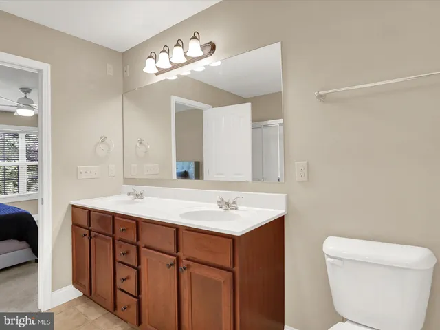 a bathroom with a toilet a sink and a mirror