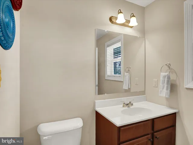 a bathroom with a toilet a sink and mirror