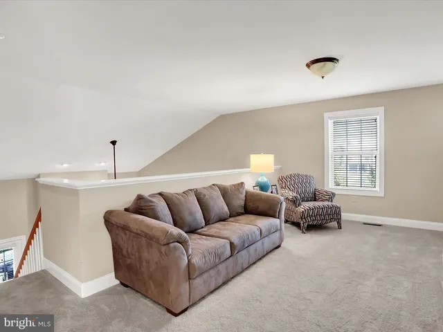 a living room with furniture gym equipment and windows