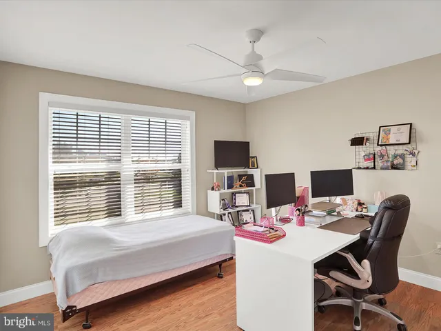 a bedroom with a workspace