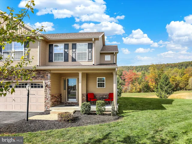 a view of a house with backyard porch and sitting area