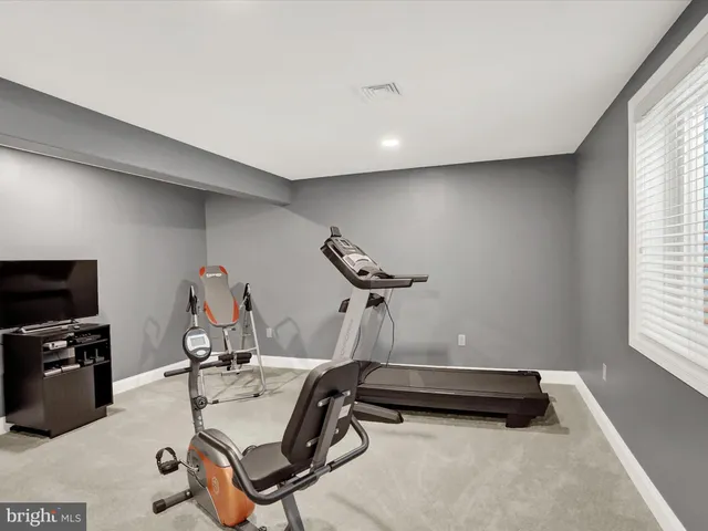 a room with gym equipment and windows
