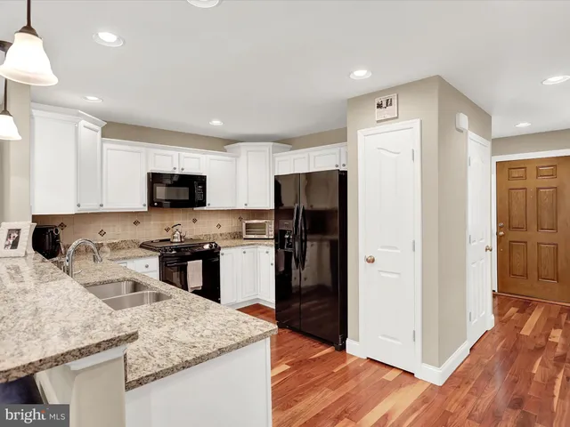 a kitchen with a refrigerator stove and sink