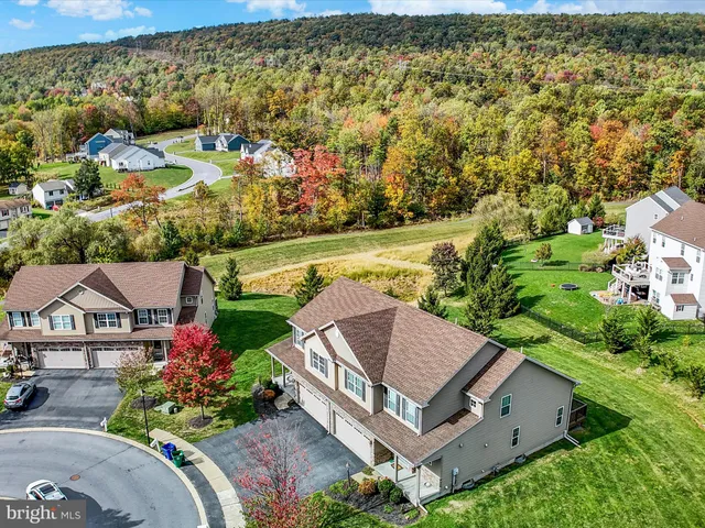 an aerial view of a house with a garden and swimming pool