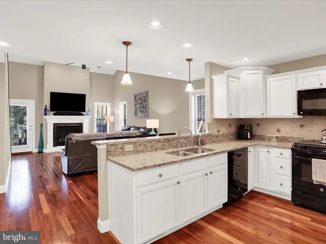 a kitchen with a sink stove and microwave