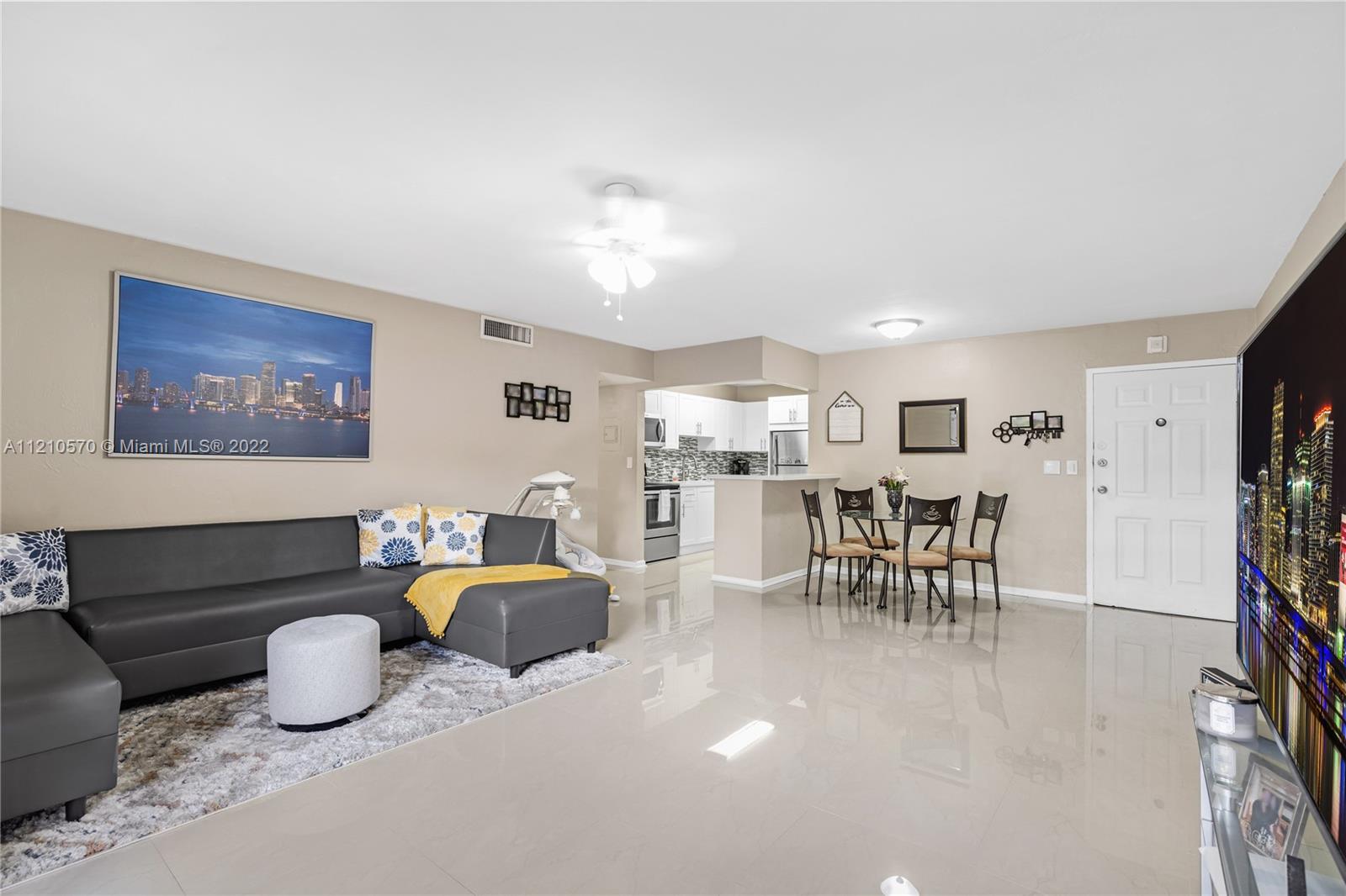 9459 Southwest 76th Street, Unit R7 Miami, FL 33173 - Photo 11 of 24 a living room with furniture gym equipment and a view of kitchen