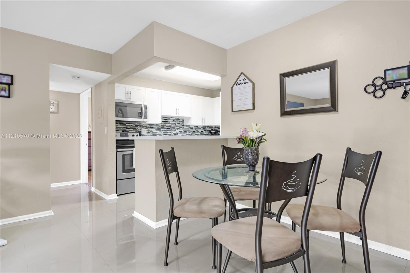 9459 Southwest 76th Street, Unit R7 Miami, FL 33173 - Photo 12 of 24 a dining room with furniture and window
