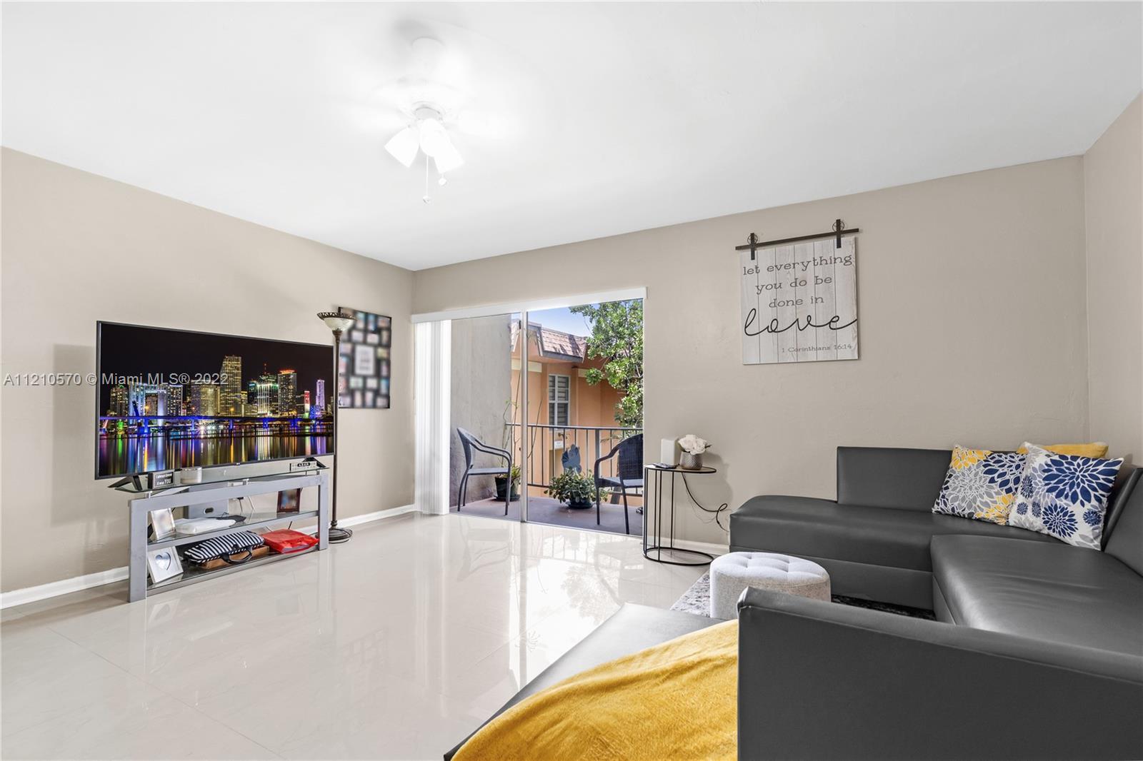 9459 Southwest 76th Street, Unit R7 Miami, FL 33173 - Photo 13 of 24 a living room with furniture and a flat screen tv