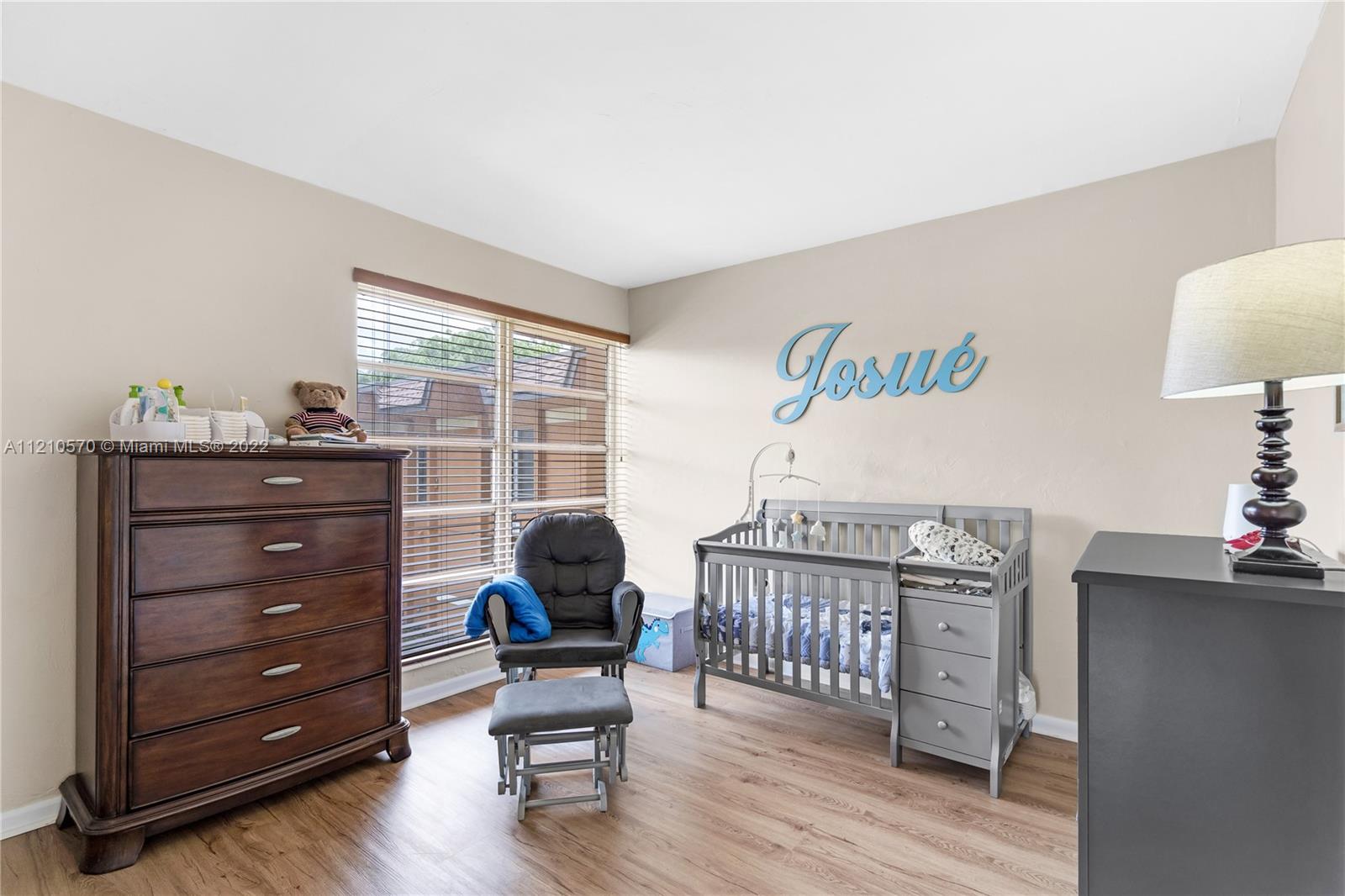 9459 Southwest 76th Street, Unit R7 Miami, FL 33173 - Photo 17 of 24 a living room with furniture and a window