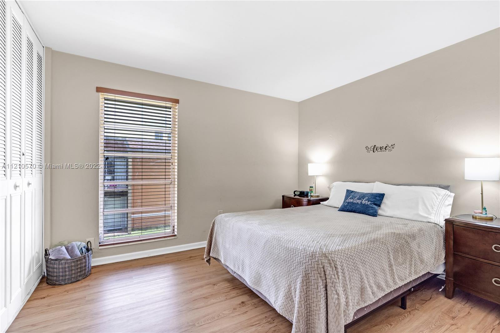 9459 Southwest 76th Street, Unit R7 Miami, FL 33173 - Photo 21 of 24 a bedroom with bed and window