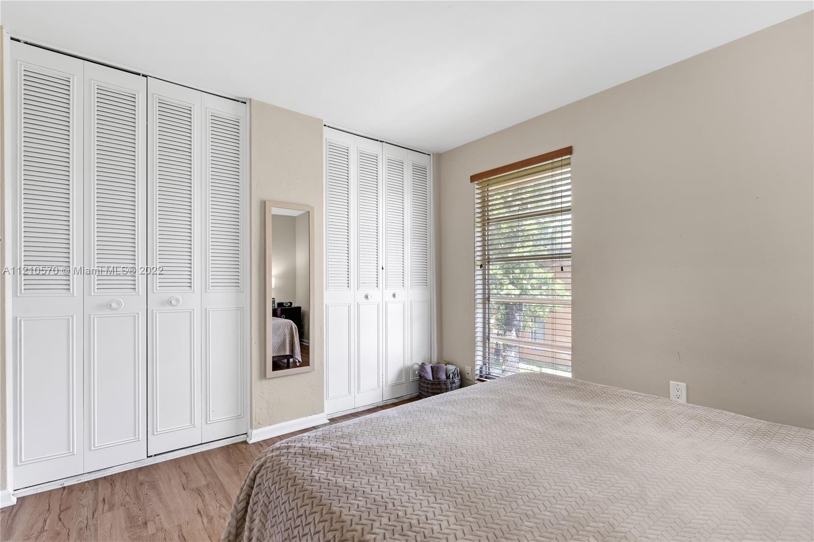 9459 Southwest 76th Street, Unit R7 Miami, FL 33173 - Photo 22 of 24 a bedroom with a bed and a window