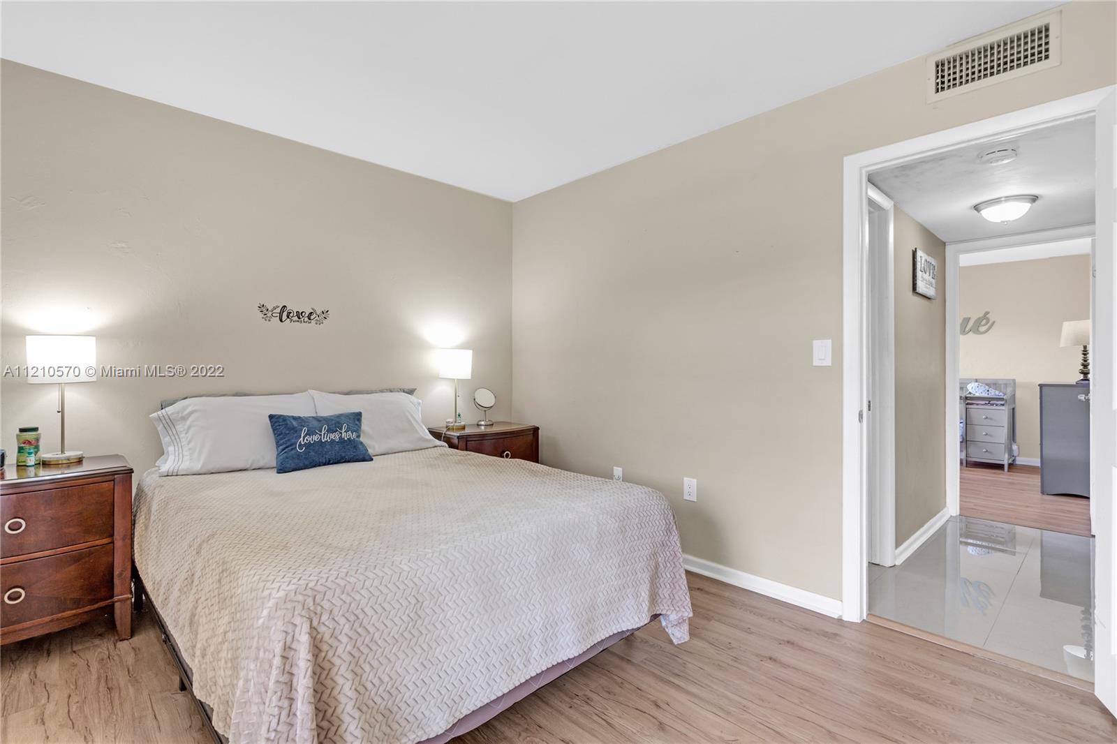 9459 Southwest 76th Street, Unit R7 Miami, FL 33173 - Photo 23 of 24 a bedroom with a bed and a view of bedroom