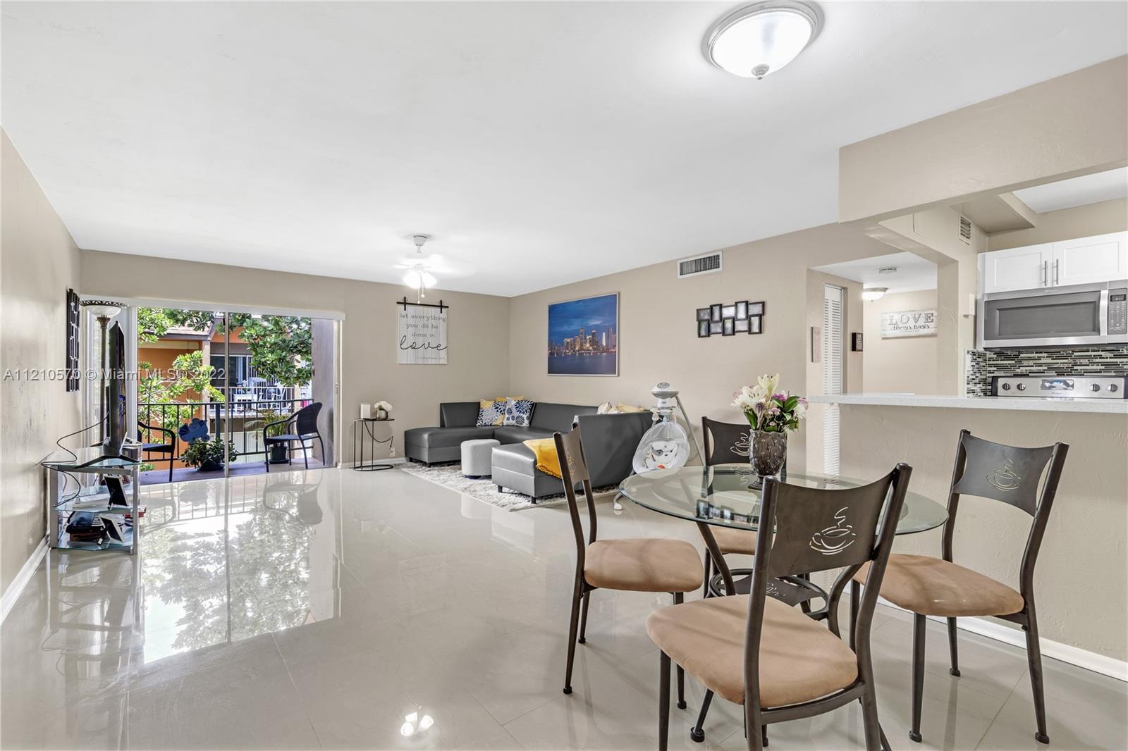9459 Southwest 76th Street, Unit R7 Miami, FL 33173 - Photo 8 of 24 a living room with furniture and a table