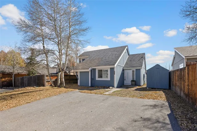 a view of a house with a yard covered in snow
